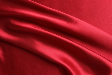 Texture of beautiful red silk fabric as background, closeup