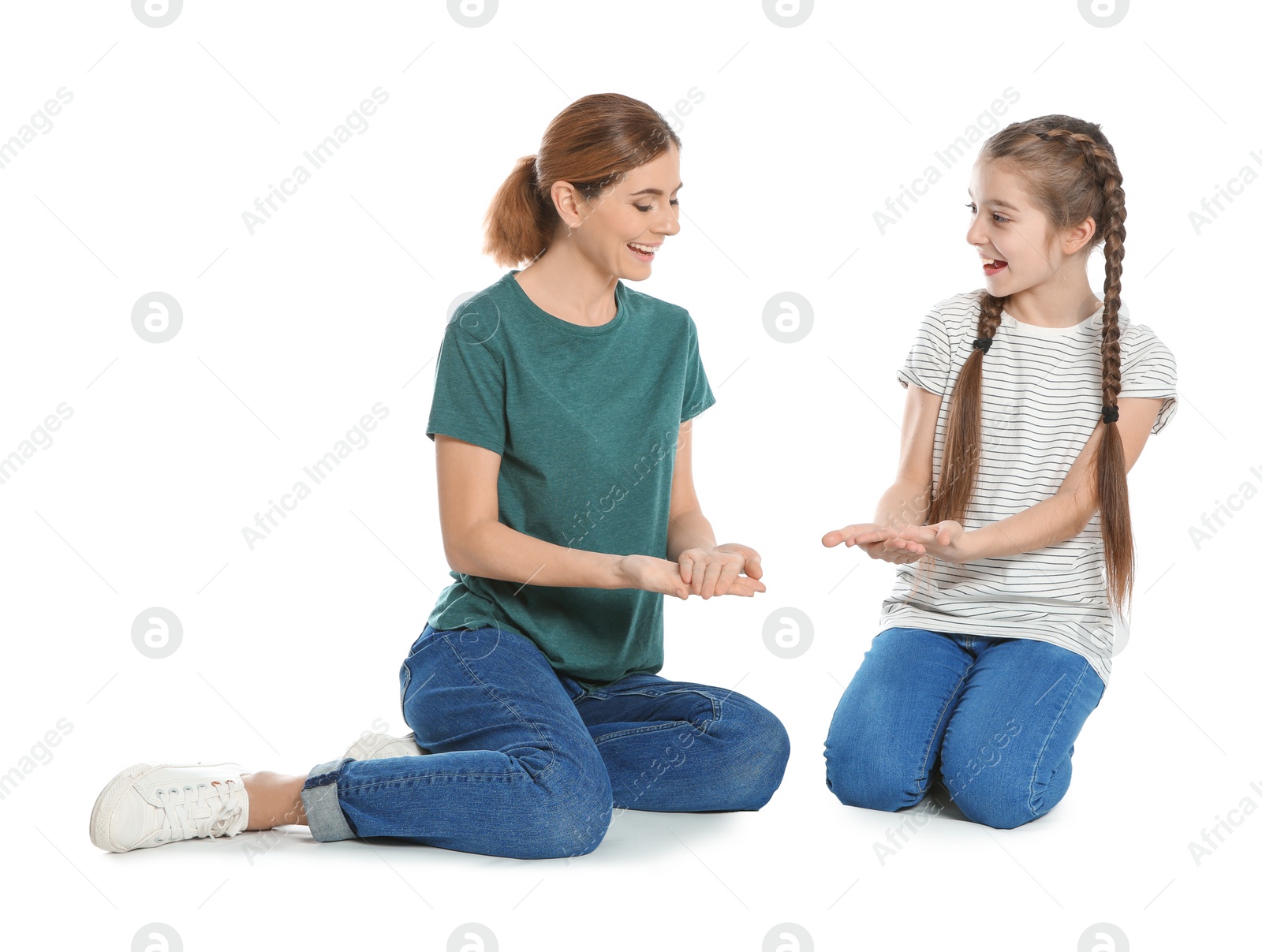 Photo of Hearing impaired mother and her child talking with help of sign language on white background