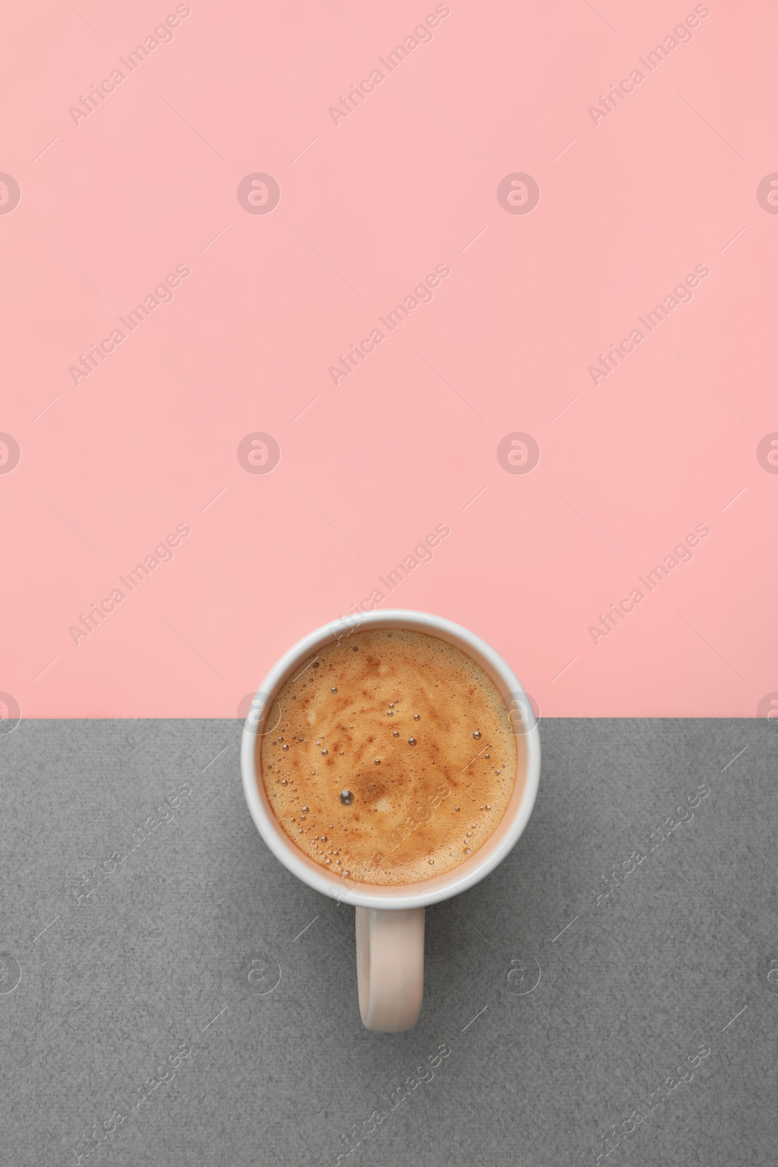 Photo of Cup of coffee on color background, top view. Space for text