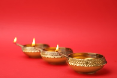 Photo of Diwali diyas or clay lamps on color background