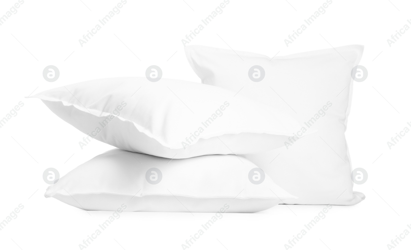 Photo of Three new soft pillows isolated on white