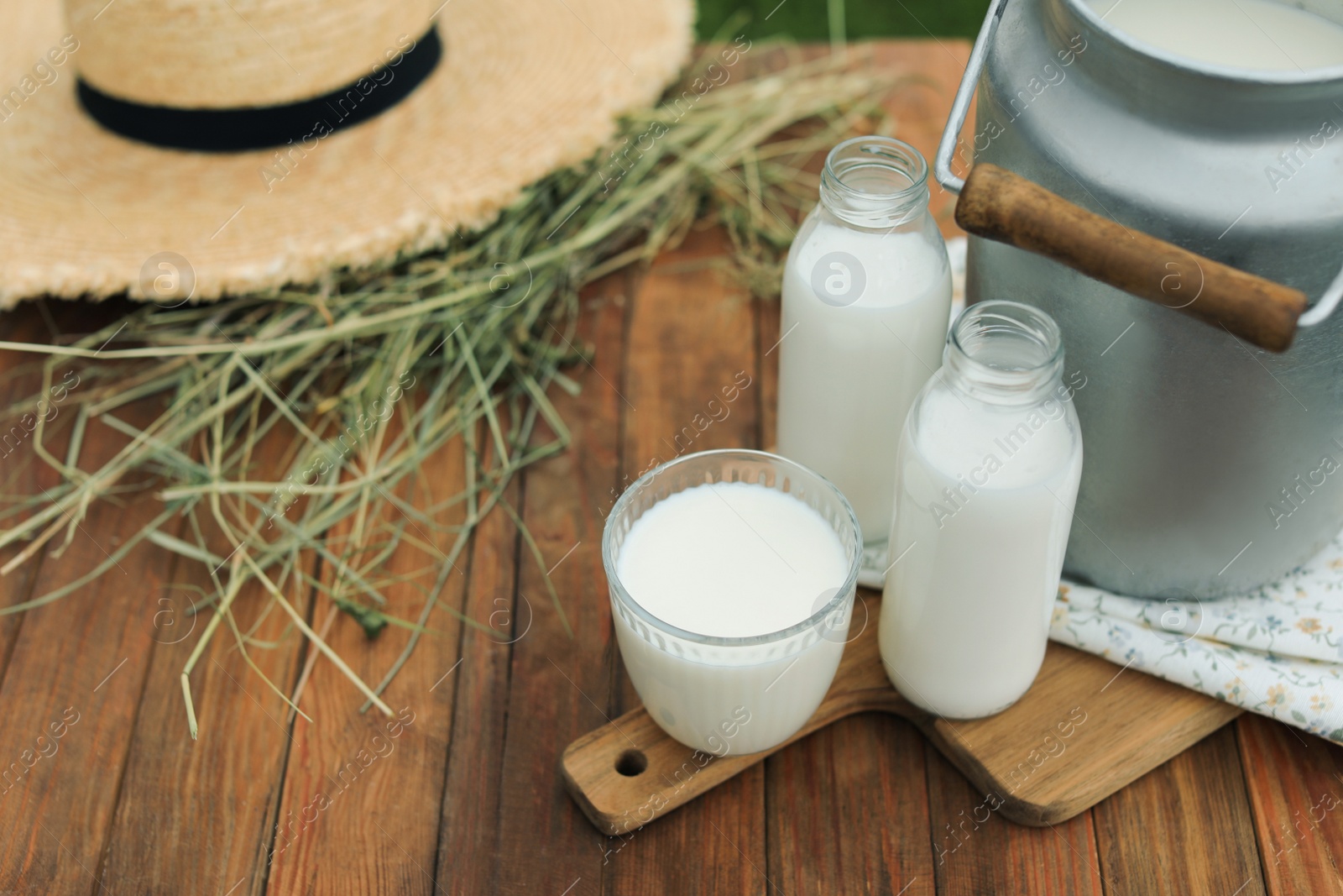 Photo of Fresh milk on wooden table. Space for text