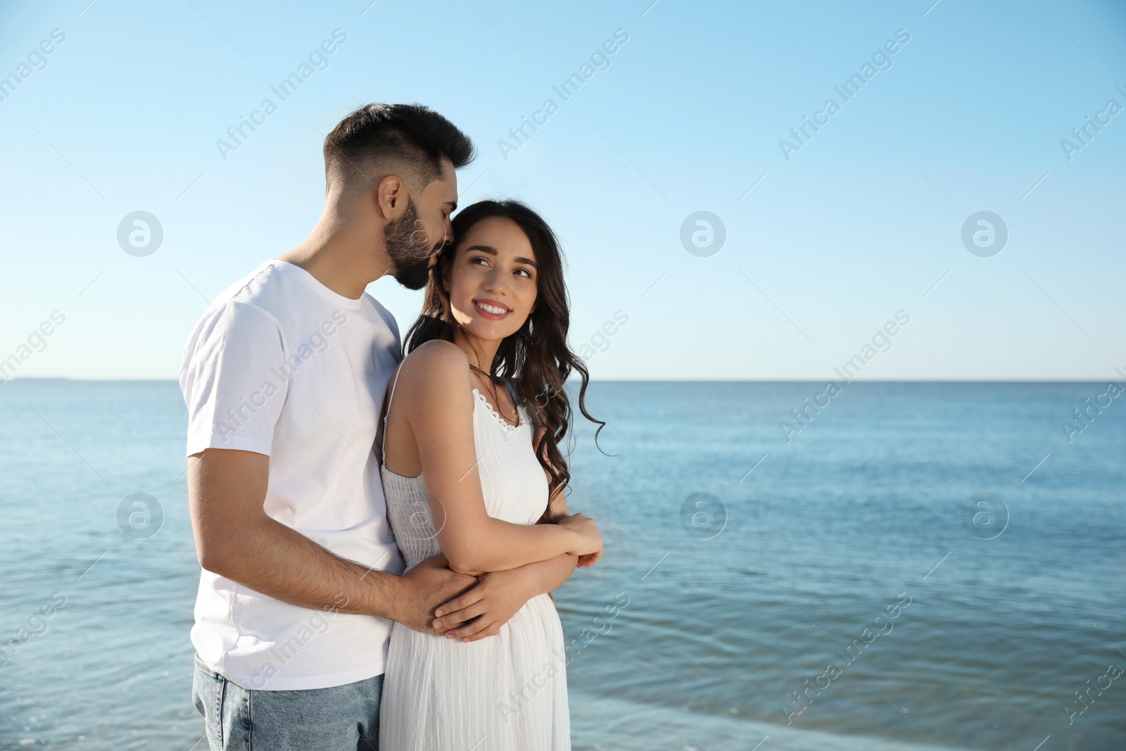 Photo of Happy young couple at beach. Honeymoon trip