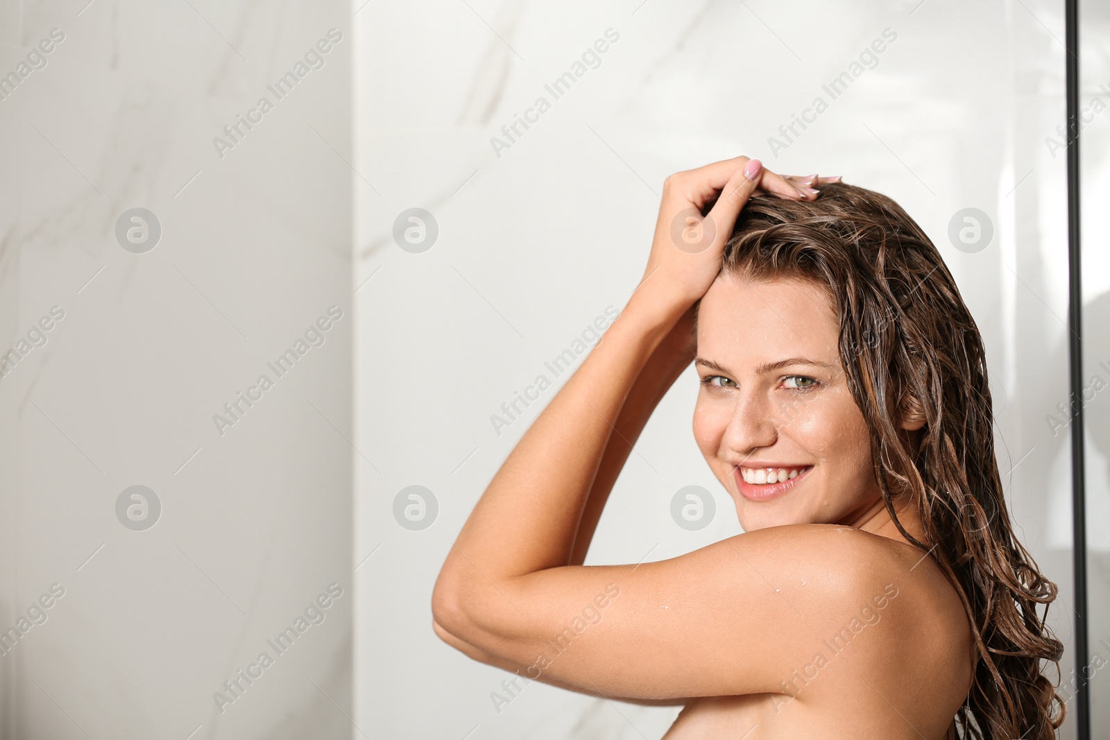 Image of Beautiful young woman taking shower at home. Space for text