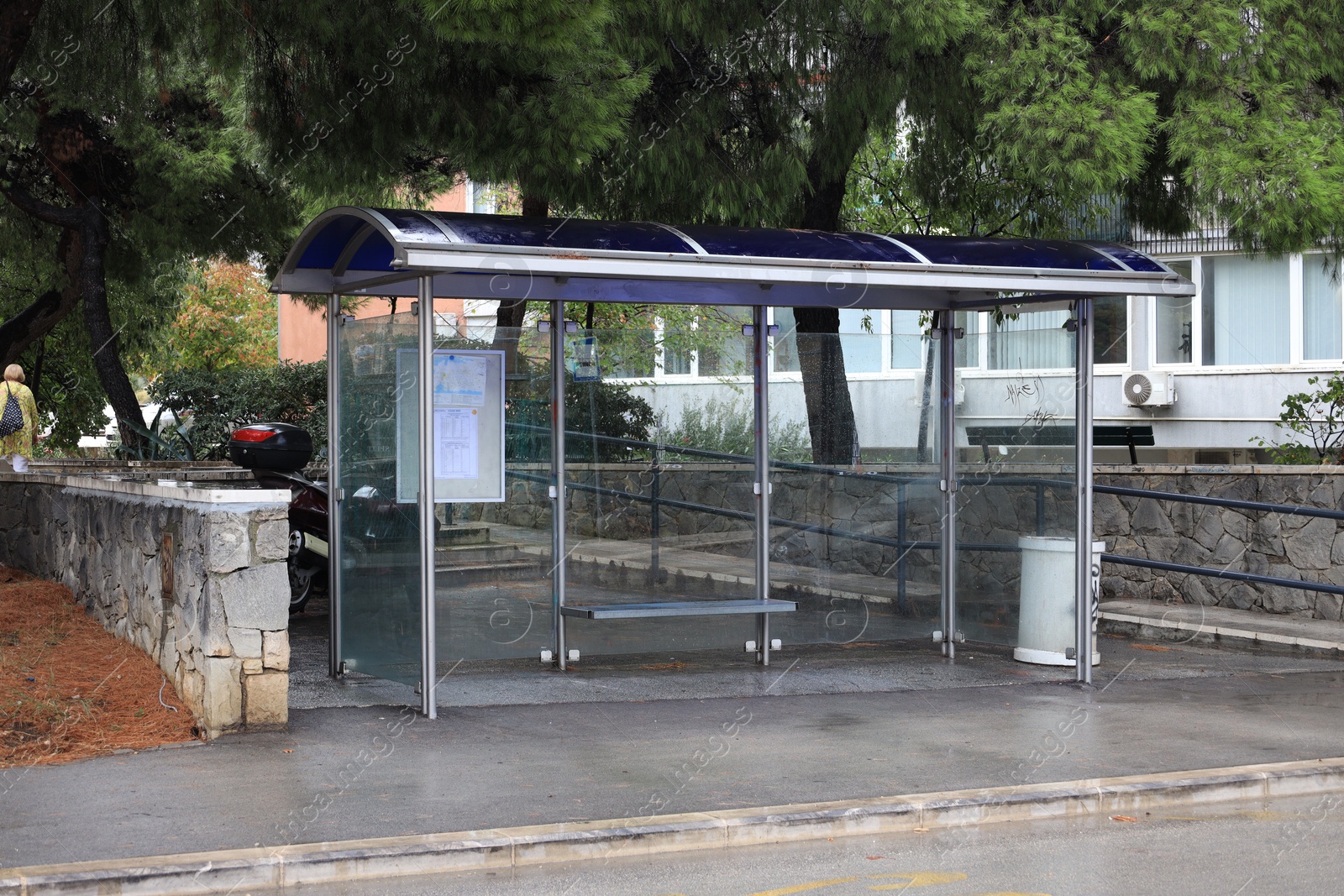 Photo of Public transport stop with bench on city street