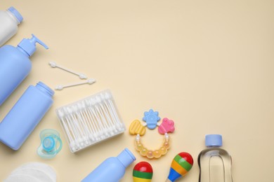 Photo of Flat lay composition with baby care products and accessories on beige background, space for text