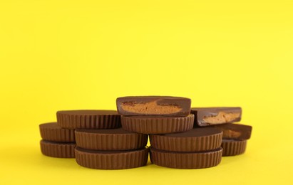 Photo of Sweet peanut butter cups on yellow background