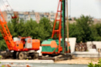 Photo of Blurred view of construction site with heavy machinery
