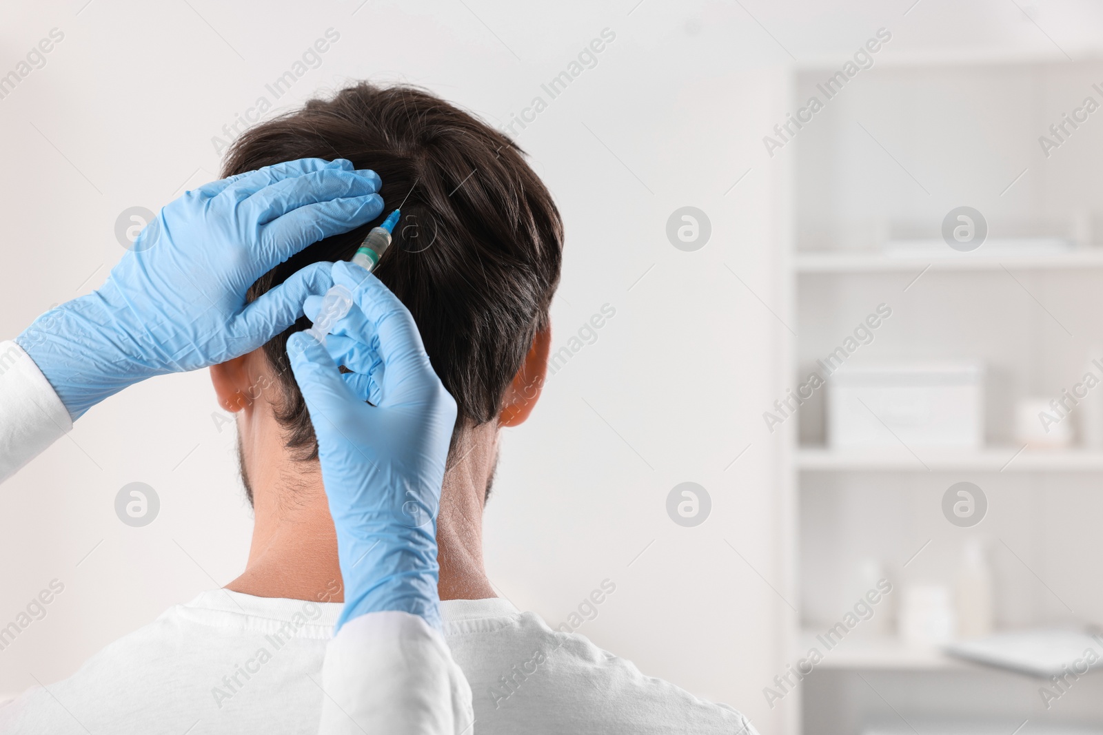 Photo of Trichologist giving injection to patient in clinic, closeup