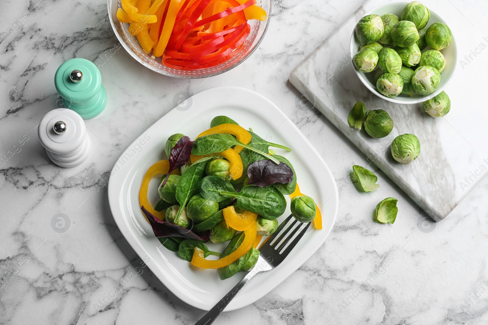 Photo of Tasty salad with Brussels sprouts served on white marble table, flat lay