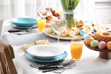 Photo of Festive Easter table setting with traditional meal at home