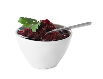 Delicious beetroot puree with parsley and spoon in bowl isolated on white. Healthy food