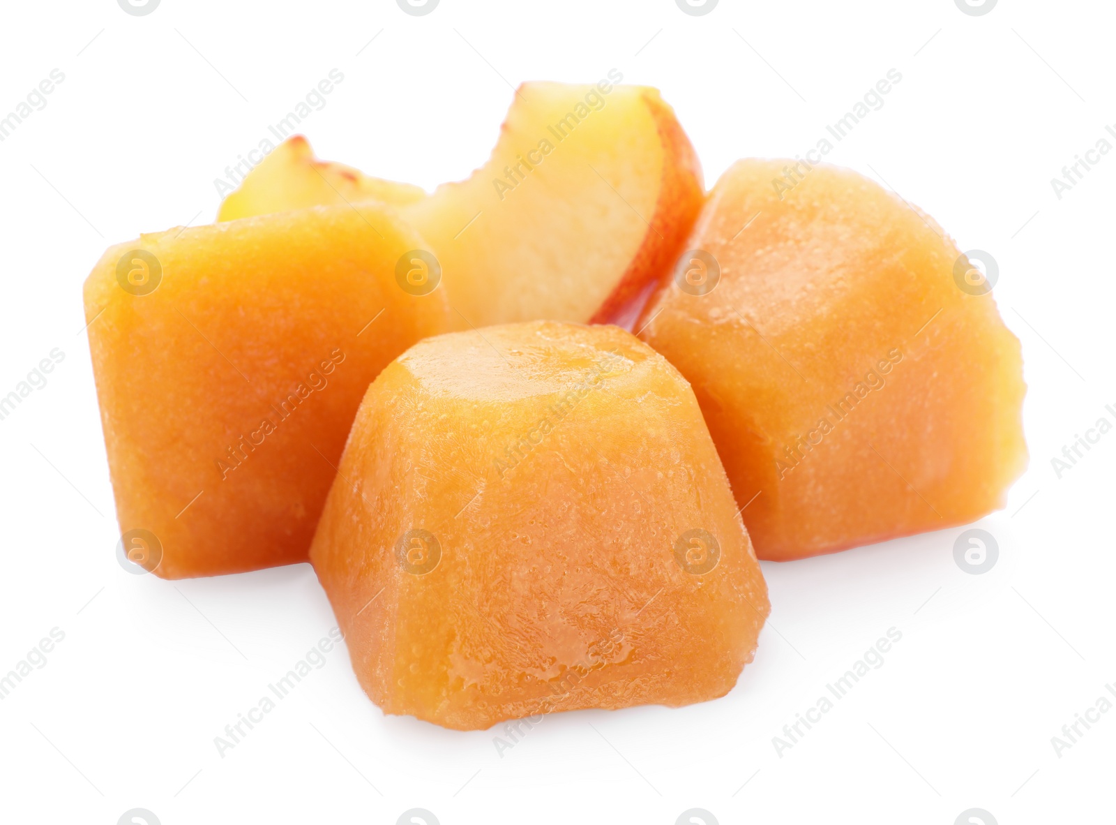 Photo of Frozen nectarine puree cubes and fruit on white background