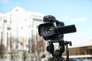 Photo of Professional digital video camera on city street