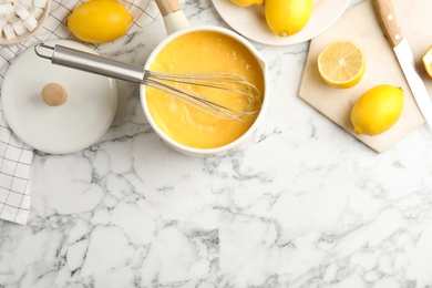 Delicious lemon curd and fresh fruits on white marble table, flat lay. Space for text