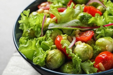 Bowl of salad with Brussels sprouts on table, closeup