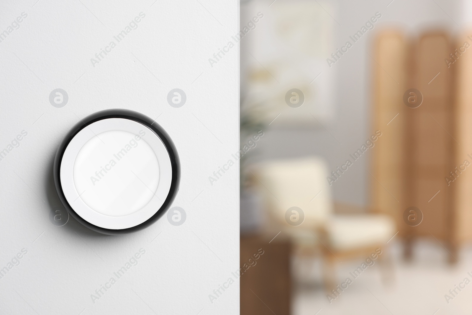 Photo of One thermostat on white wall indoors, space for text. Smart home system