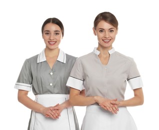Photo of Portrait of chambermaids in tidy uniforms on white background