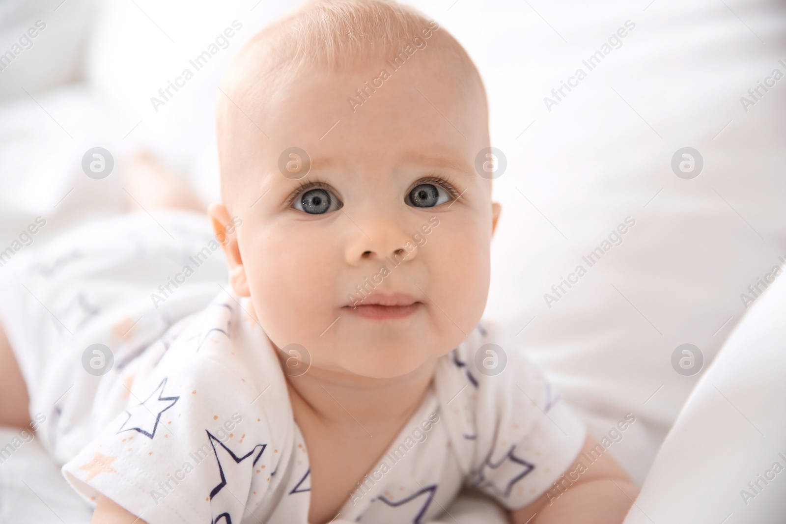 Photo of Cute little baby on bed at home