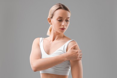 Photo of Woman with sporty body on grey background