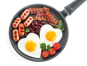 Photo of Delicious breakfast with heart shaped eggs and sausages isolated on white, top view
