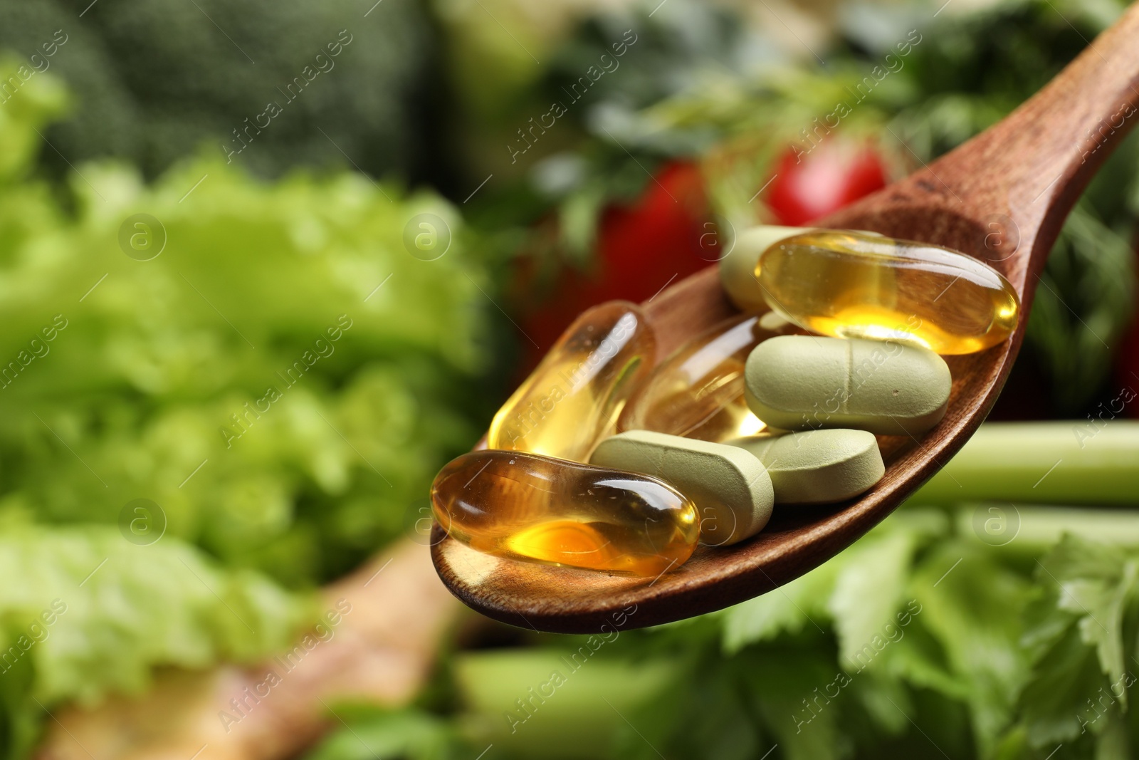 Photo of Dietary supplements. Spoon with pills over food products, closeup