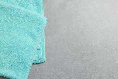 Photo of Soft folded towel on gray background, above view. Space for text