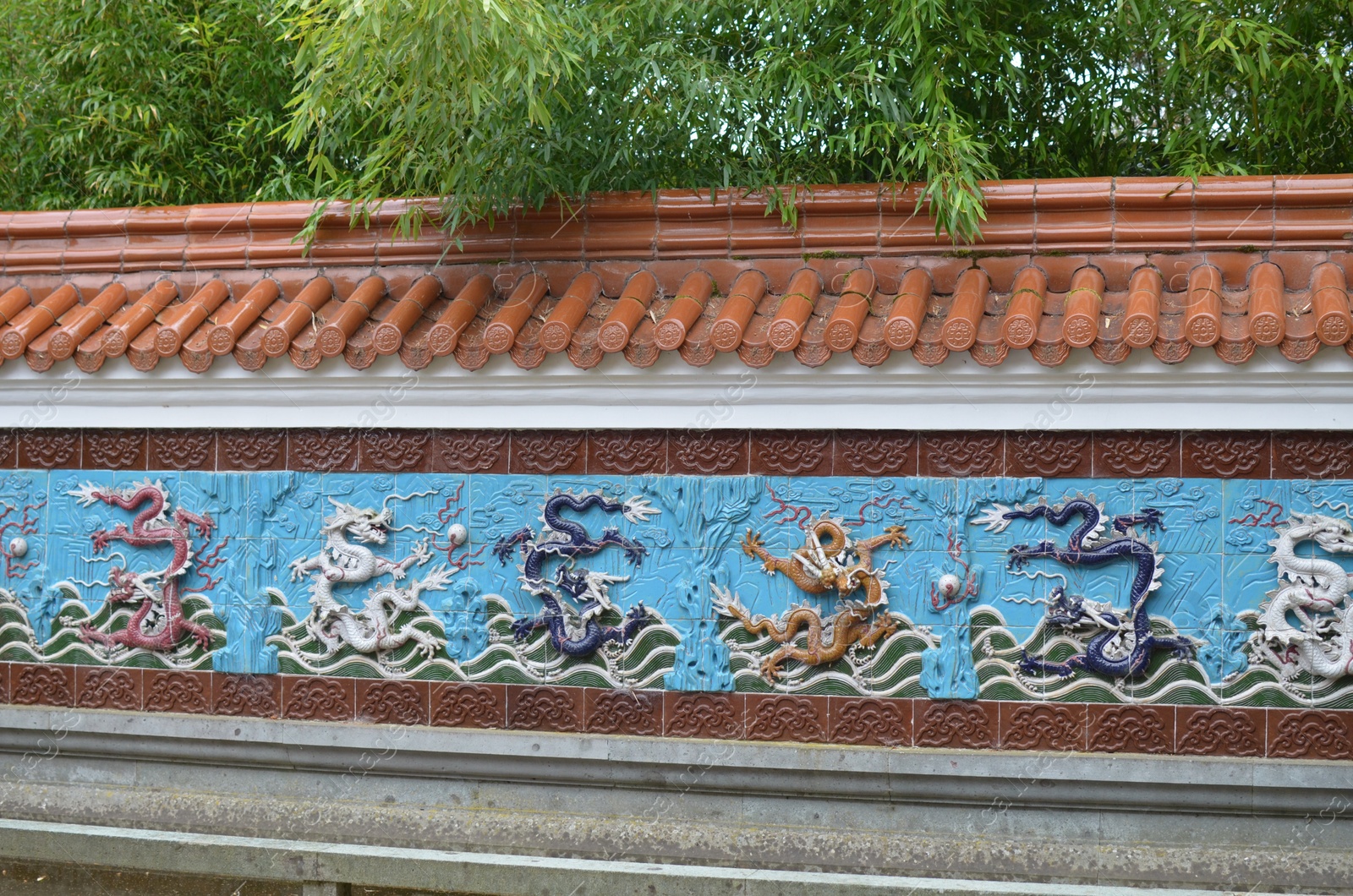 Photo of HAREN, NETHERLANDS - MAY 23, 2022: View of Nine-Dragon wall in Chinese garden