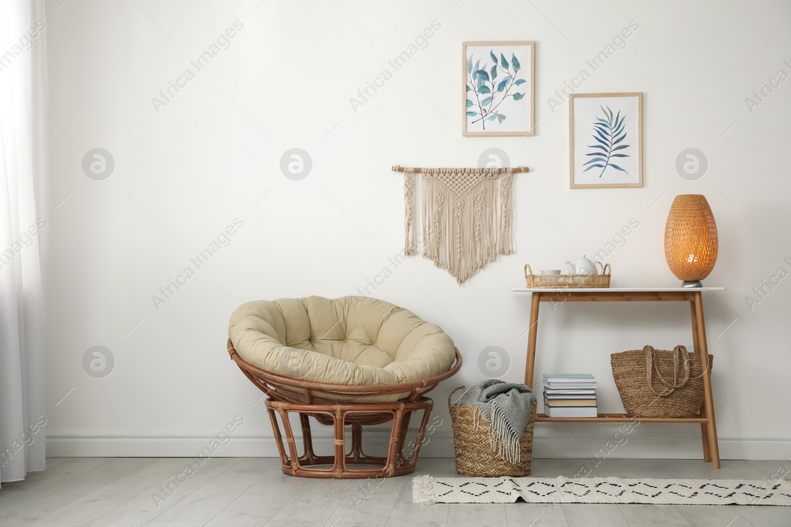 Photo of Living room interior design with comfortable papasan chair and wooden table