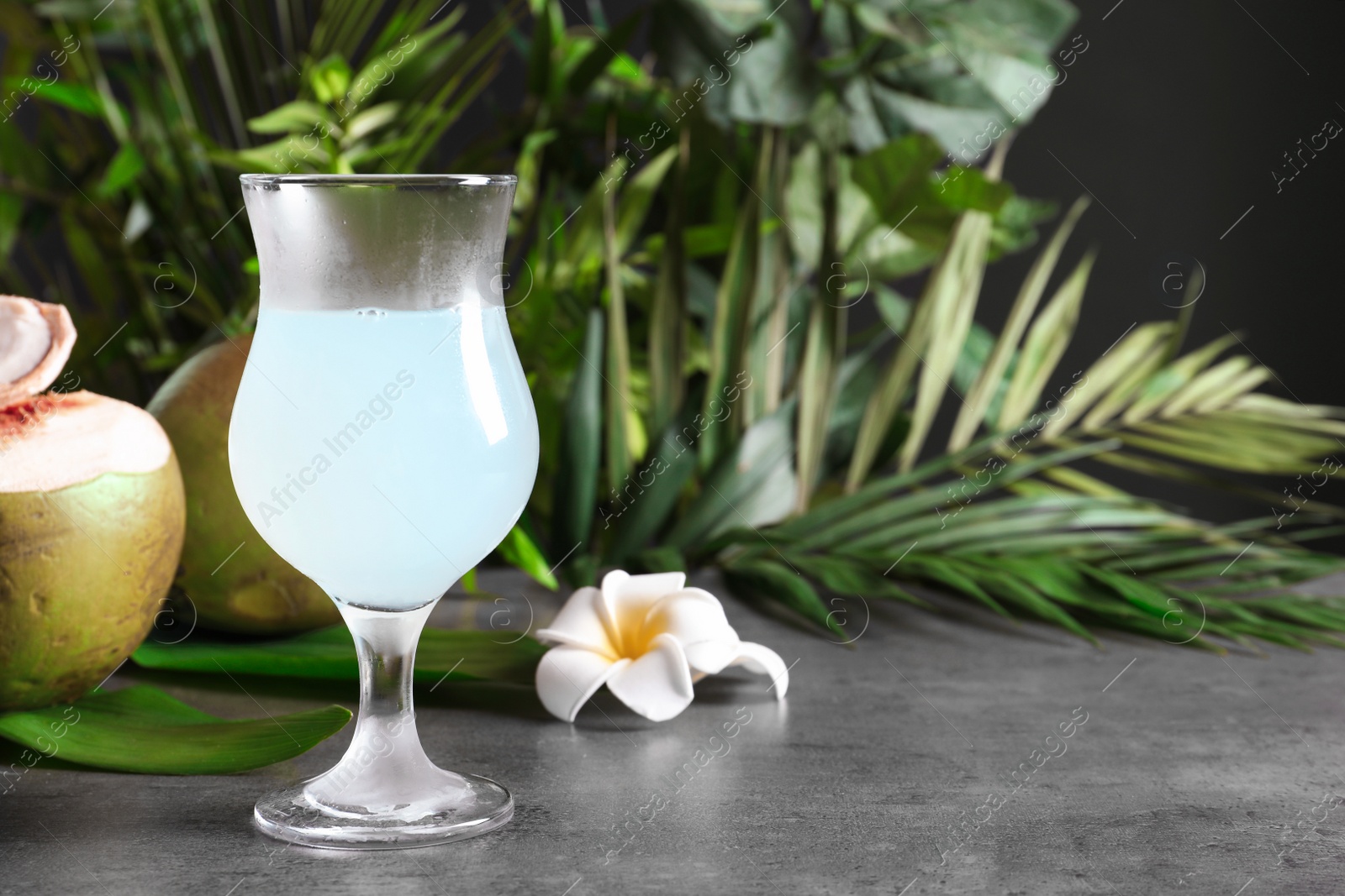 Photo of Glass of fresh coconut water on table