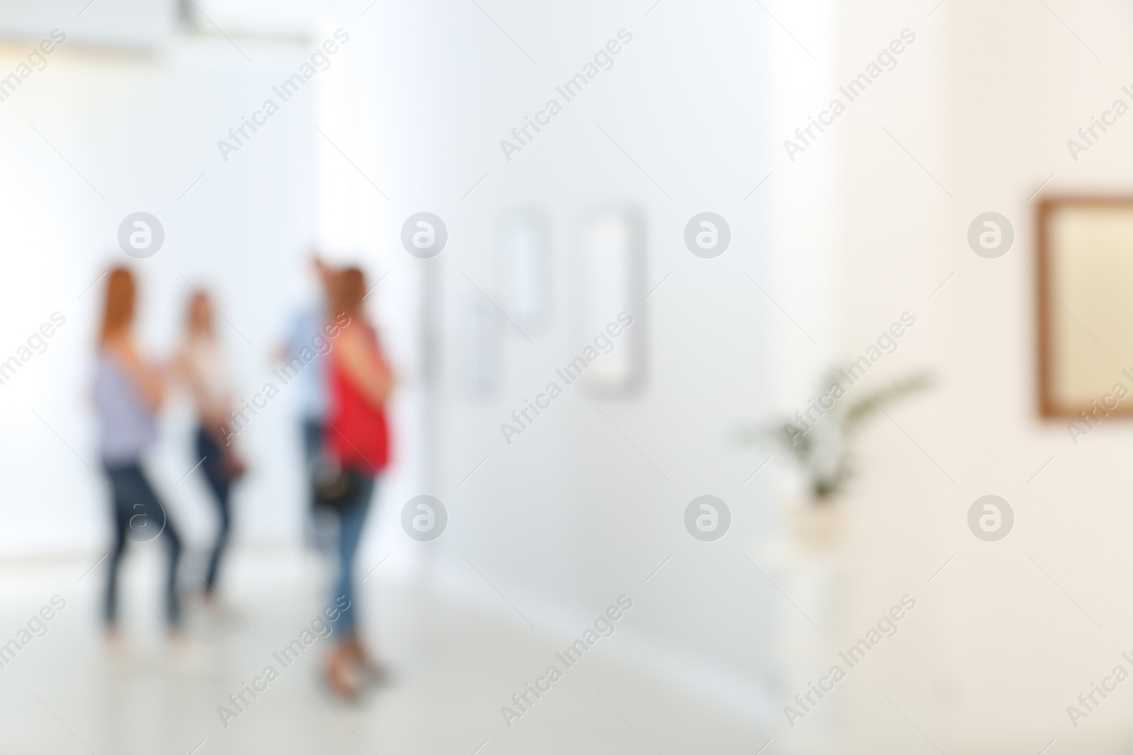 Photo of People in modern art gallery, blurred view