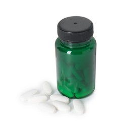 Photo of Bottle and pile of vitamin pills isolated on white