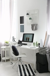 Photo of Comfortable workplace with computer on desk in home office