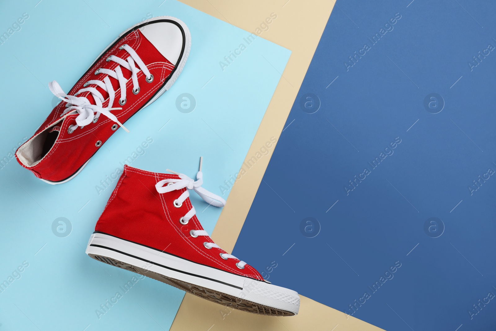 Photo of Stylish sneakers on color background, flat lay. Space for text