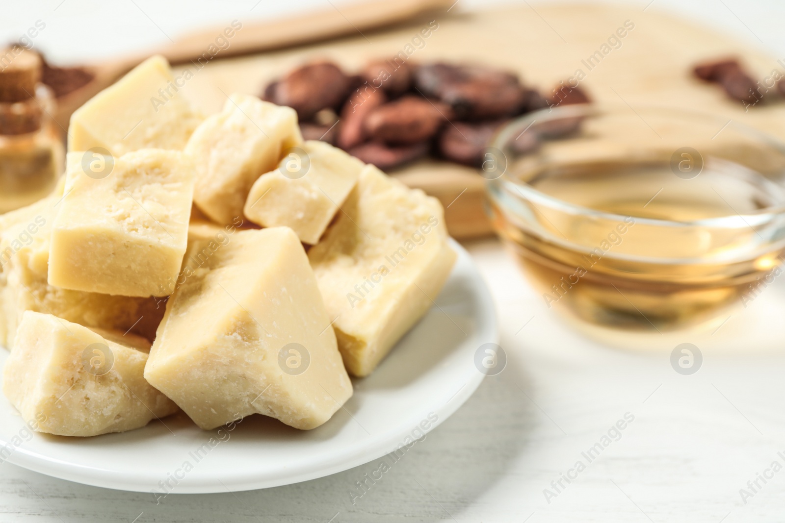 Photo of Organic cocoa butter on wooden table, closeup