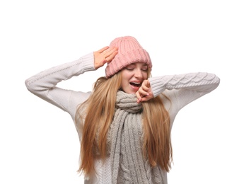 Portrait of emotional young woman in stylish hat and sweater with scarf on white background. Winter atmosphere