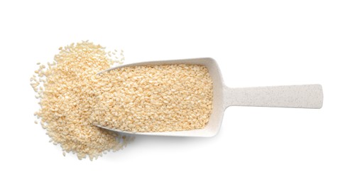 Photo of Plastic scoop with sesame seeds on white background, top view