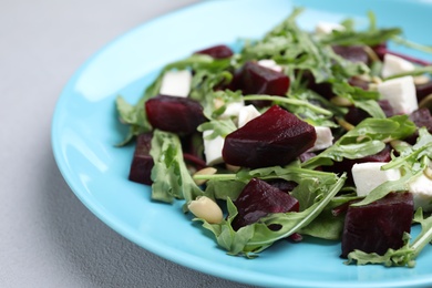 Photo of Fresh delicious beet salad on grey table, closeup