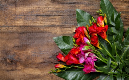 Beautiful freesia bouquet on wooden background