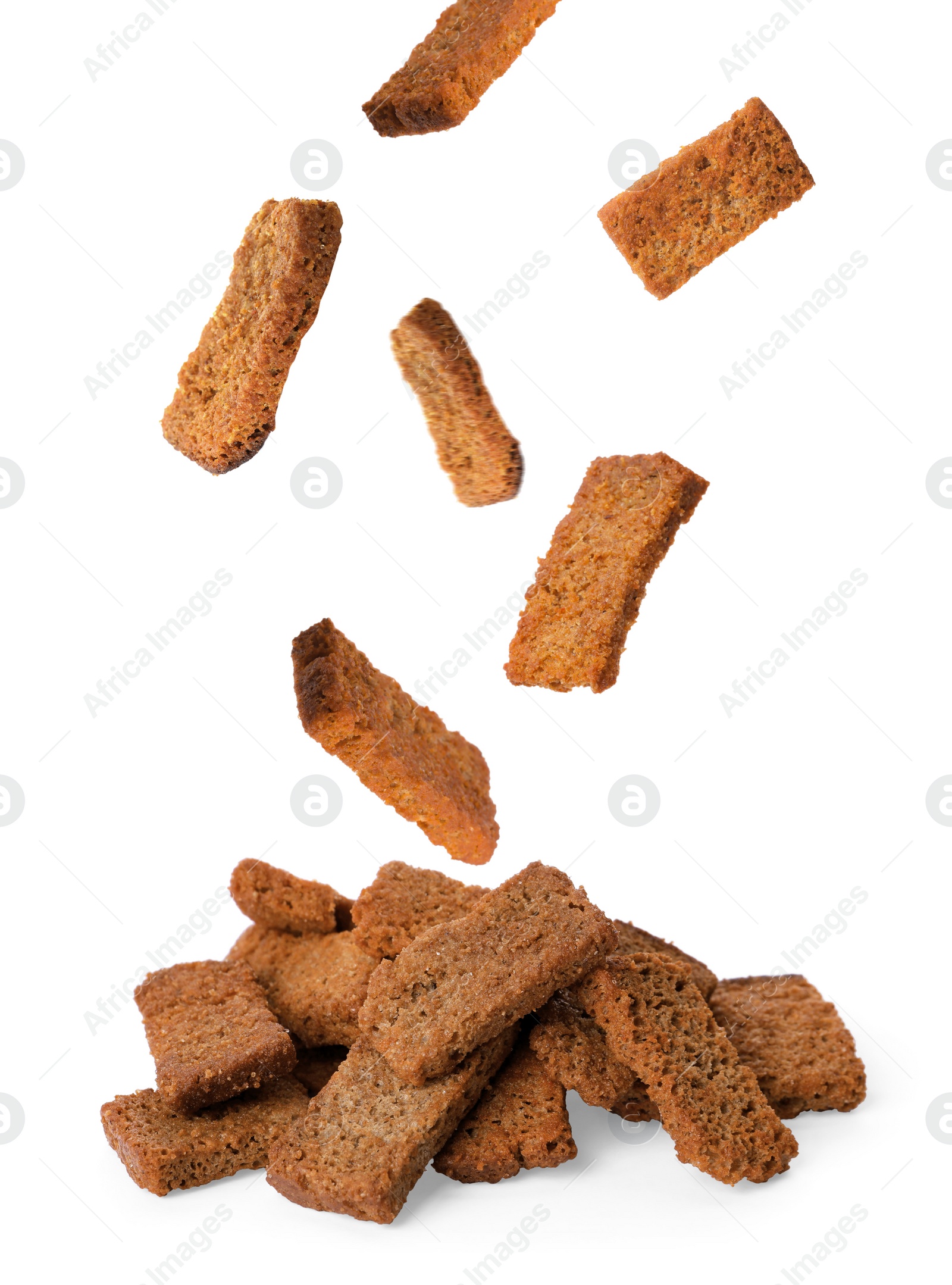 Image of Delicious crispy rusks falling into pile on white background