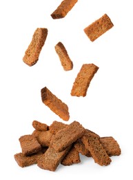 Image of Delicious crispy rusks falling into pile on white background