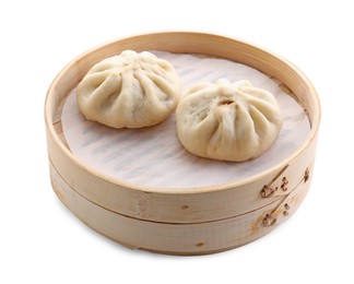 Photo of Delicious bao buns (baozi) in bamboo steamer isolated on white