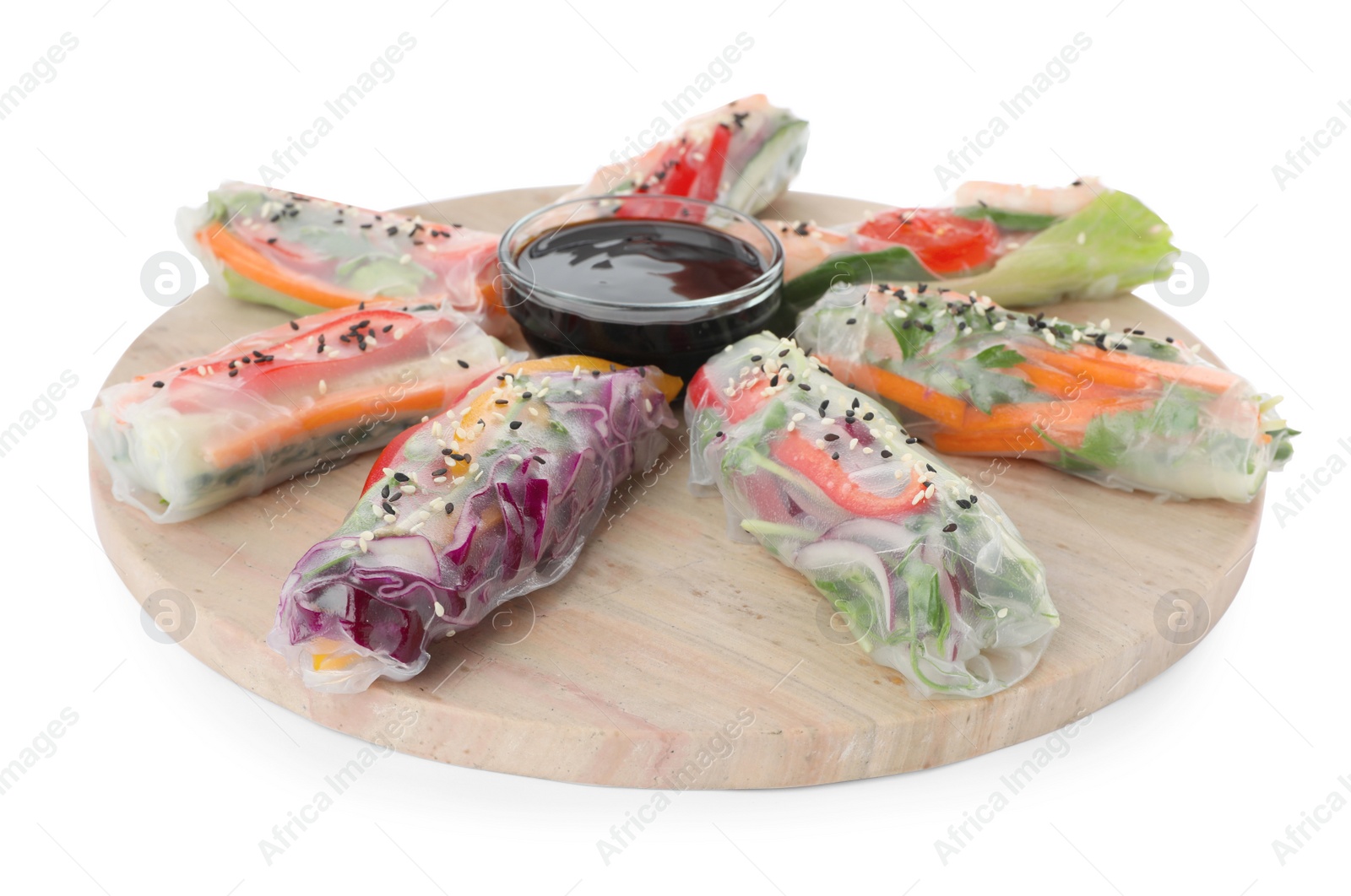 Photo of Serving board with delicious rolls wrapped in rice paper and teriyaki sauce on white background