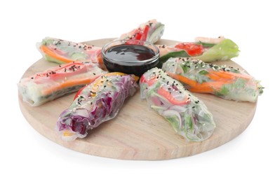 Serving board with delicious rolls wrapped in rice paper and teriyaki sauce on white background