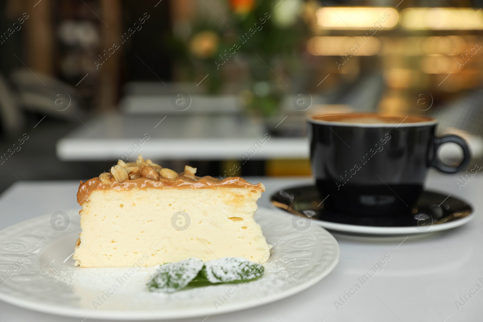 Photo of Tasty dessert and cup of fresh coffee on table in cafeteria