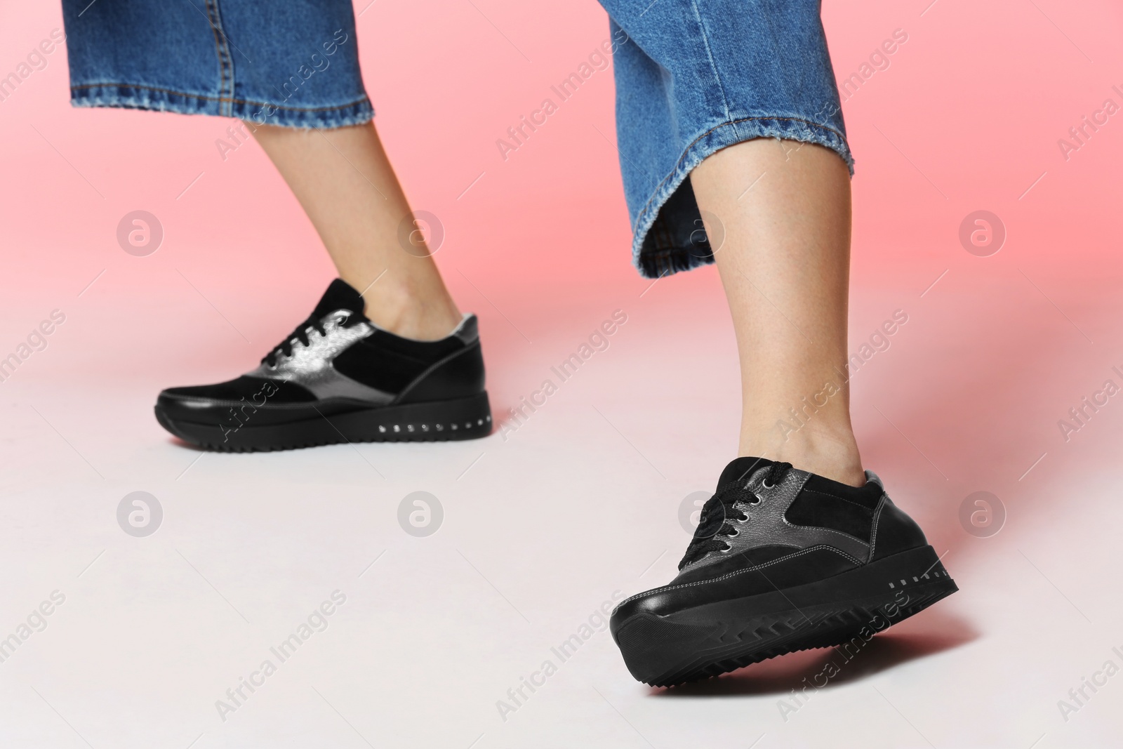 Photo of Woman in stylish shoes on color background, closeup