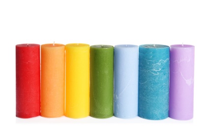 Photo of Different colorful wax candles on white background