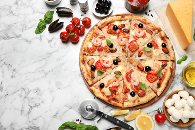 Photo of Tasty pizza with seafood and ingredients on white marble table, flat lay. Space for text