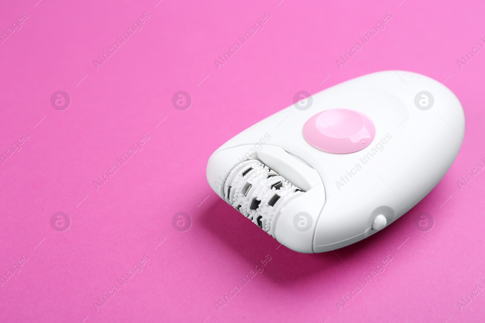 Photo of Modern epilator on purple background. Space for text