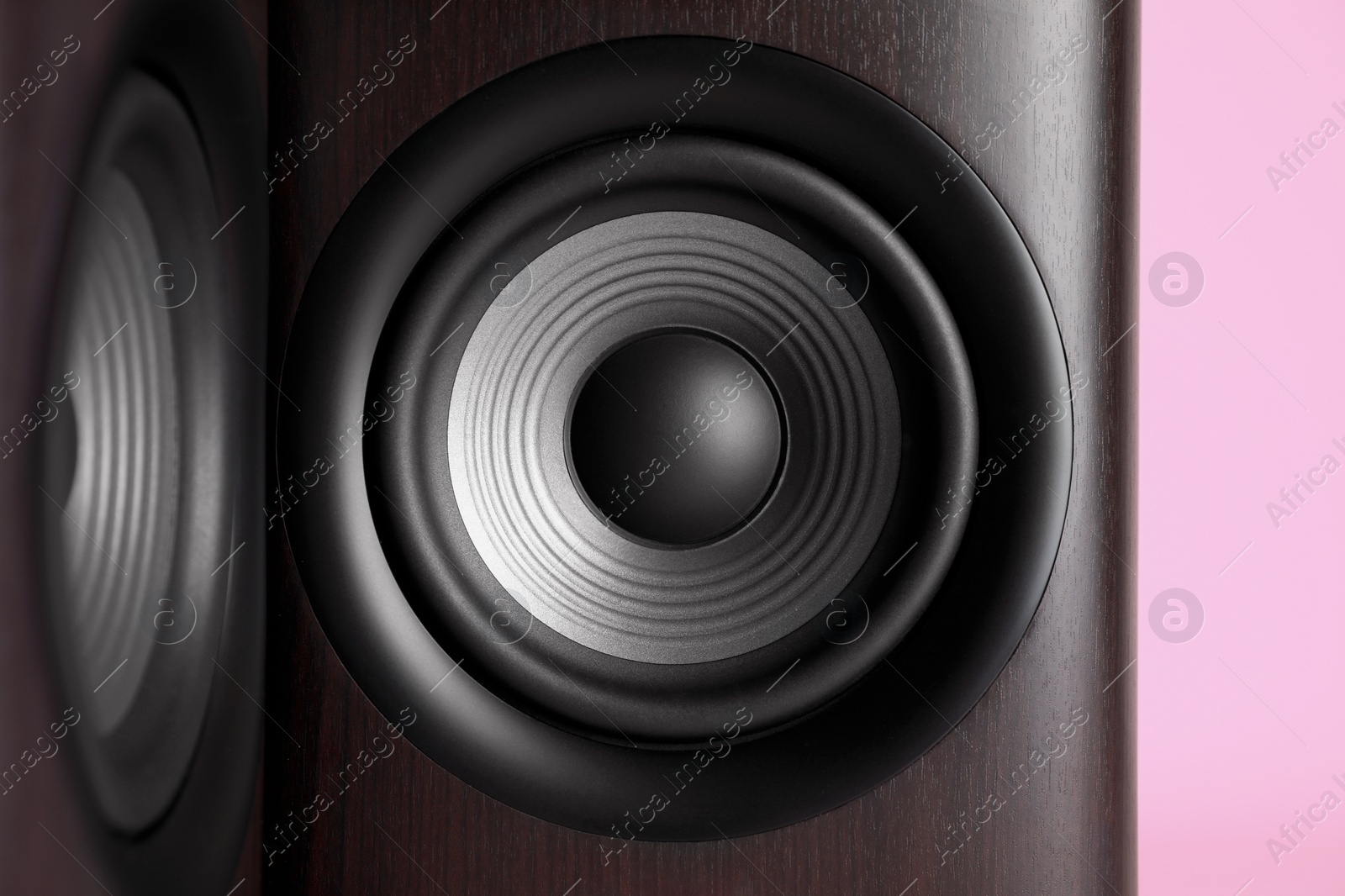 Photo of Wooden sound speakers on pink background, closeup